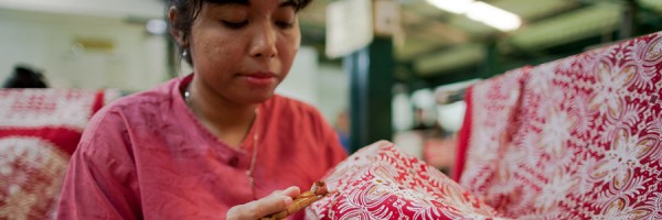 Applying hot wax to create batik designs.